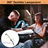 A tattoo artist is working on a client's arm, illuminated by a flexible LED lamp. Produktbild-Vorschau
