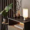 A modern nightstand with a lamp and plants. Produktbild-Vorschau