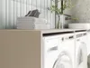 A modern laundry room with stacked towels on top of a washing machine. Voir les images du produit