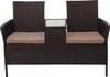 A brown poly-rattan bench with a small table in the center and tan cushions, shown against a white background. Náhled obrázku produktu