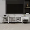 A modern white TV cabinet with open doors and shelves, displaying books, a clock, and decorative items. A large black TV screen is mounted on the wall behind it. Náhľad obrázku produktu