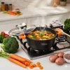 A pot of soup is cooking on a stovetop, surrounded by fresh vegetables. Voir les images du produit