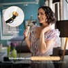 A woman is styling her hair with a curling iron in a bright, modern room. Anteprima dell’immagine prodotto