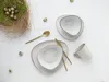 A flat lay of a tableware set with quail eggs and a nest. Náhľad obrázku produktu