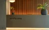 A reception desk with the company name "mebano" in front of a slatted wood wall. Produktbild-Vorschau