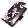 A black flip phone case with a pink and white hibiscus floral pattern, shown open with a phone inside. Produktbild-Vorschau