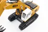 A close-up, high-angle view of a yellow and white toy excavator on a white background. Náhľad obrázku produktu