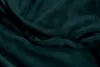 A close-up view of dark teal plush fabric with a partially open zipper. Produktbild-Vorschau