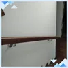 A wooden handrail mounted on a white wall, with metal brackets. Náhľad obrázku produktu