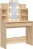 A light brown vanity table with a large illuminated mirror and shelves. Podgląd zdjęcia produktu