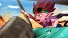 A pink-skinned character with spiky red hair and goggles is driving a vehicle through a desert landscape. Podgląd zdjęcia produktu