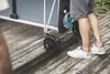 A person is moving a table tennis table on a wooden deck. Produktbild-Vorschau