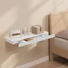 A floating shelf with items on it next to a bed. Produktbild-Vorschau