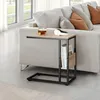 A side table next to a sofa with a cup of tea and a book. Produktbild-Vorschau