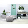 A modern living room setting with plants and decorative items. Anteprima dell’immagine prodotto