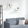 Two white floating shelves mounted on a white wall above a grey sofa. Anteprima dell’immagine prodotto