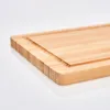 A close-up, angled view of a bamboo cutting board on a white background. Anteprima dell’immagine prodotto