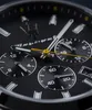A close-up shot of a black Maserati watch face, showing the chronograph sub-dials and hands. Produktbild-Vorschau