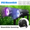 Two garden spotlights with purple and blue light shining, set against a background of wet grass. Náhled obrázku produktu