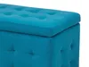 A close-up view of a tufted blue ottoman. Podgląd zdjęcia produktu