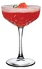 A single coupe glass filled with a red cocktail and garnished with a pink rose and a sprig of greenery. Náhled obrázku produktu
