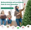 A family decorating a Christmas tree indoors. Voir les images du produit