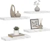 Four white marble effect shelves are displayed against a white background, each with decorative items. Produktbild-Vorschau