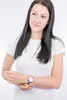 A woman wearing a white t-shirt and a watch on her wrist. Náhľad obrázku produktu