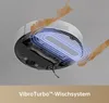 The underside of a robot vacuum cleaner is shown, with a graphic overlay indicating its mopping system and liquid splashing around it. Produktbild-Vorschau
