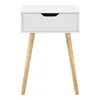 A white bedside table with a drawer and wooden legs, presented on a white background. Náhled obrázku produktu