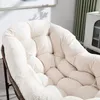 Close-up of a plush, beige corduroy cushion on a chair. Anteprima dell’immagine prodotto