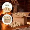 A fireplace with burning logs and a cardboard box filled with wood briquettes. Anteprima dell’immagine prodotto
