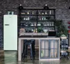 A modern kitchen scene with a retro-style refrigerator, a kitchen island with stools, and shelving units filled with various items. Produktbild-Vorschau