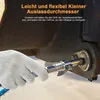 A gloved hand is using a grease gun coupler to connect to a grease fitting on heavy machinery. Produktbild-Vorschau