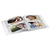 An open photo album displaying multiple pictures of children. Voir les images du produit