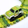 A green toy car is on a colorful race track. Produktbild-Vorschau