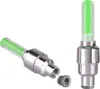 Two green LED valve caps for bicycle tires are shown against a white background. One is upright, and the other is lying on its side with a small threaded cap next to it. Náhľad obrázku produktu