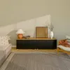 A living room scene featuring a sideboard with decorative items and a chair with a throw blanket. Voir les images du produit