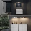 A split image showing a modern bathroom with a shower and vanity on top, and a living room or hallway with a console and large window on the bottom. Produktbild-Vorschau