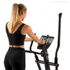 A woman is using an elliptical trainer. Podgląd zdjęcia produktu