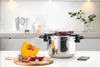 A pressure cooker is displayed on a countertop with ingredients and a smartphone nearby. Náhľad obrázku produktu
