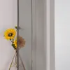 A close-up of a gray sheer curtain with sunflowers in a vase. Produktbild-Vorschau