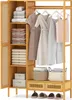 A bamboo wardrobe with clothes and folded items on shelves. Podgląd zdjęcia produktu