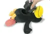 A hand is inserting a black device with colorful lights into the opening of a black plush toy shaped like a bird with a yellow beak and red and white striped feet. Produktbild-Vorschau