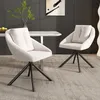 Two beige upholstered chairs with black metal legs are placed in a modern dining room setting. Voir les images du produit
