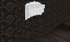 A white wall shelf with three drawers is mounted on a dark damask patterned wallpaper. The floor below is made of dark wooden planks. Produktbild-Vorschau