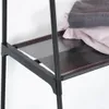 A close-up view of a black metal clothing rack with two shelves, one holding folded pink and gray fabric items. Náhľad obrázku produktu