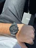 A person wearing a Hugo Boss watch and jeans, with the watch box in the background. Anteprima dell’immagine prodotto