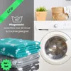 A stack of folded pet blankets next to a washing machine, with a plant and basket on top of the machine. Náhled obrázku produktu