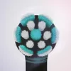 A close-up view of a black electric toothbrush head with teal and white bristles. Produktbild-Vorschau
